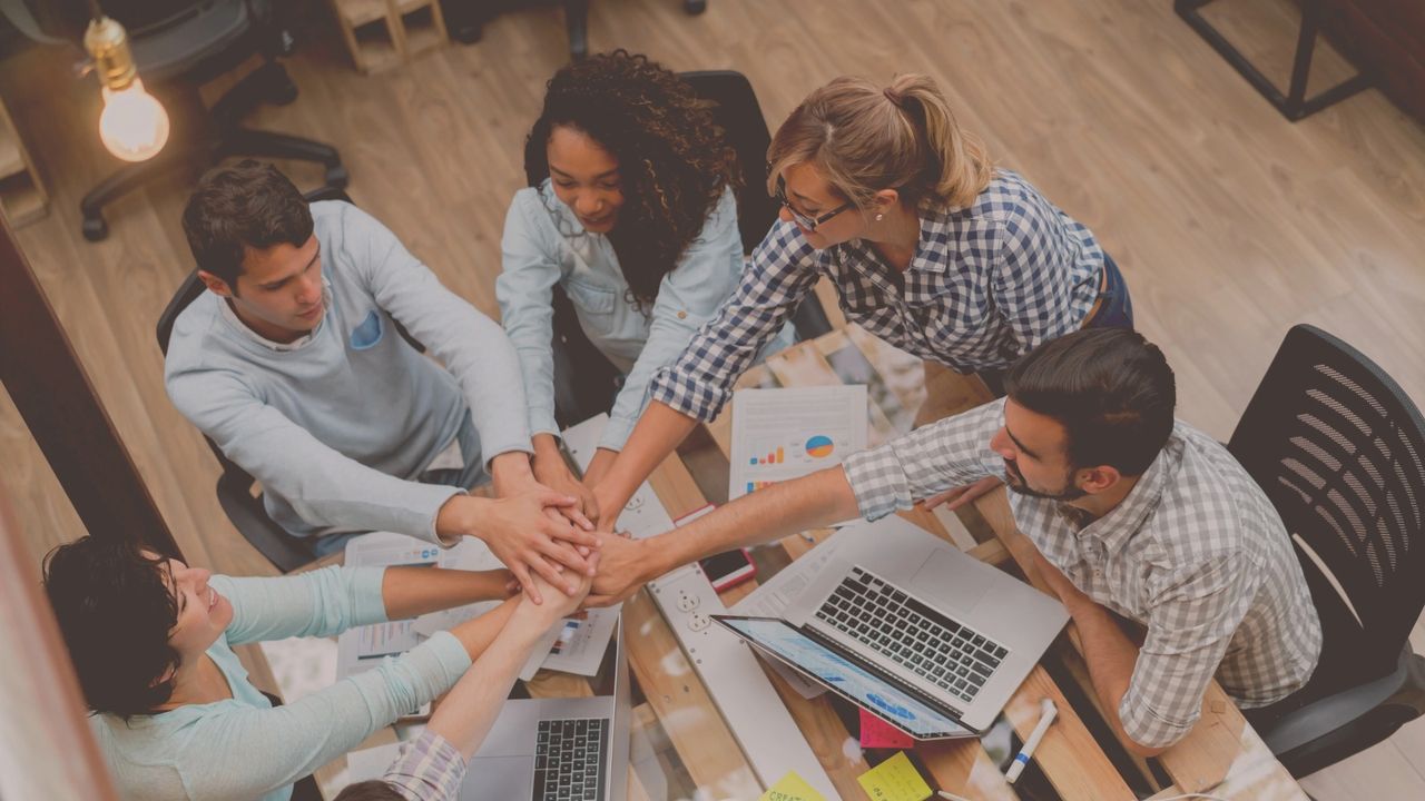 A team celebrates after completing their corporate mental health plan.