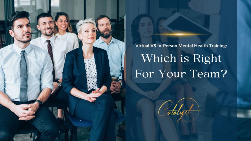 A group of corporate executives listens intently during an in-person mental health training seminar.