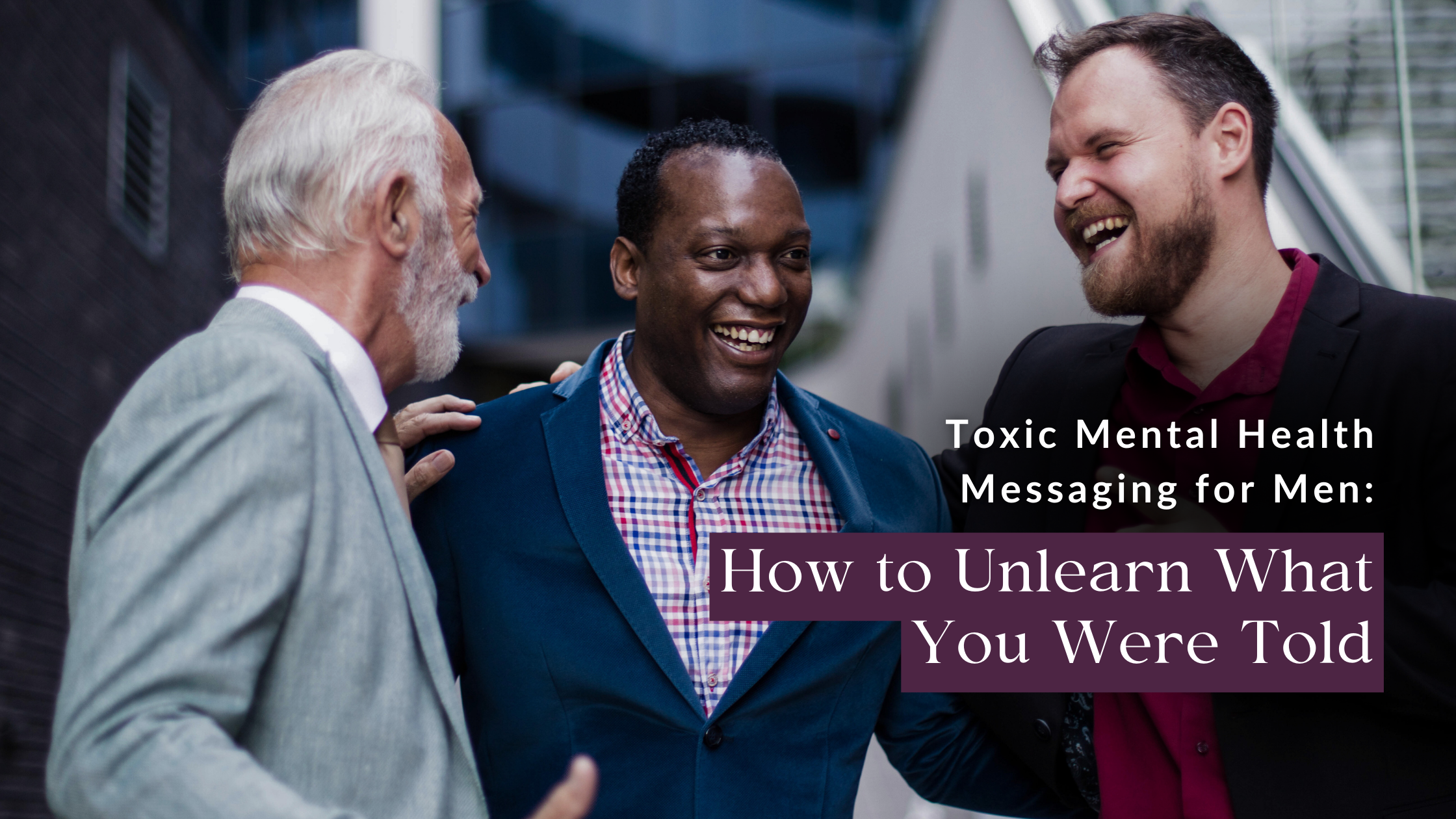 Three businessmen stand together engaging in an open conversation about men’s mental health.